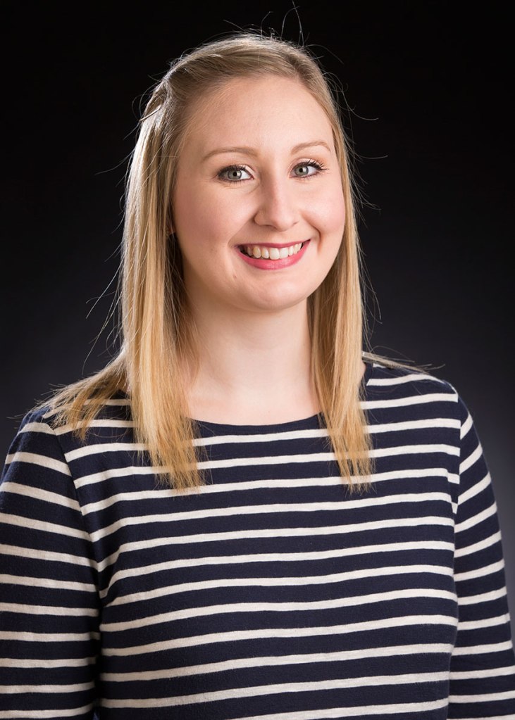 blonde woman in blue and white striped shirt